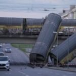 A freight trains' collision in Germany sends 2 wagons plunging off a bridge. One person was killed