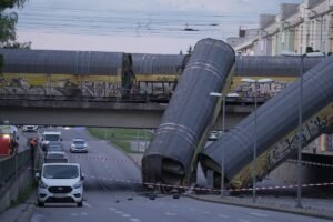 A freight trains' collision in Germany sends 2 wagons plunging off a bridge. One person was killed