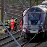 UK police probe cause of train collision that killed driver and left 9 in critical condition