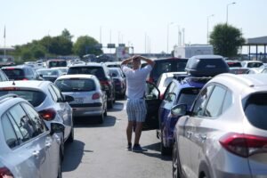 Hourslong waits at Croatia-Serbia border test travelers' resolve in sweltering heat